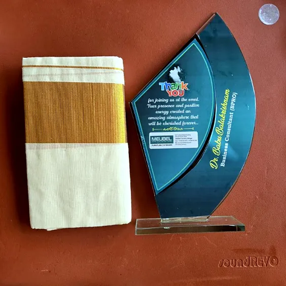 Client appreciation plaque presented to Dr. Babu Balakrishnan